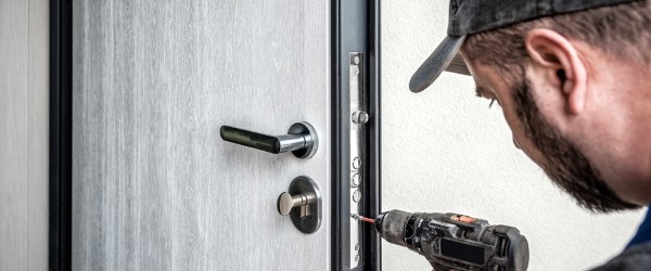 Locksmith repairing entrance door lock