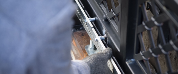 Specialist carries out work on installation and commissioning of sliding gates. Professional service of installation and maintenance of automatic cantilever sliding gate